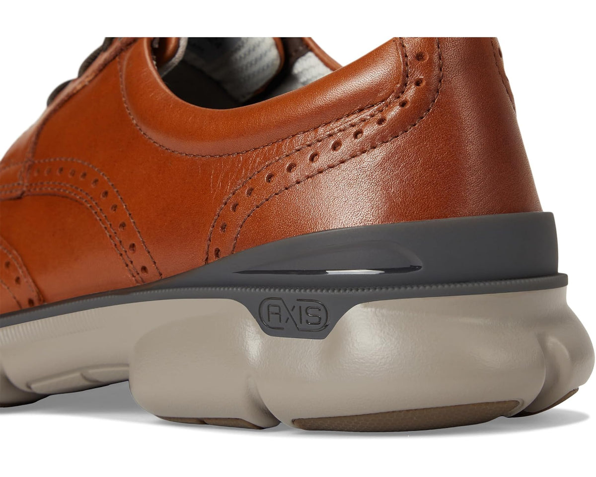 Tan oxford shoe close-up of cushioned sole with logo plate detail