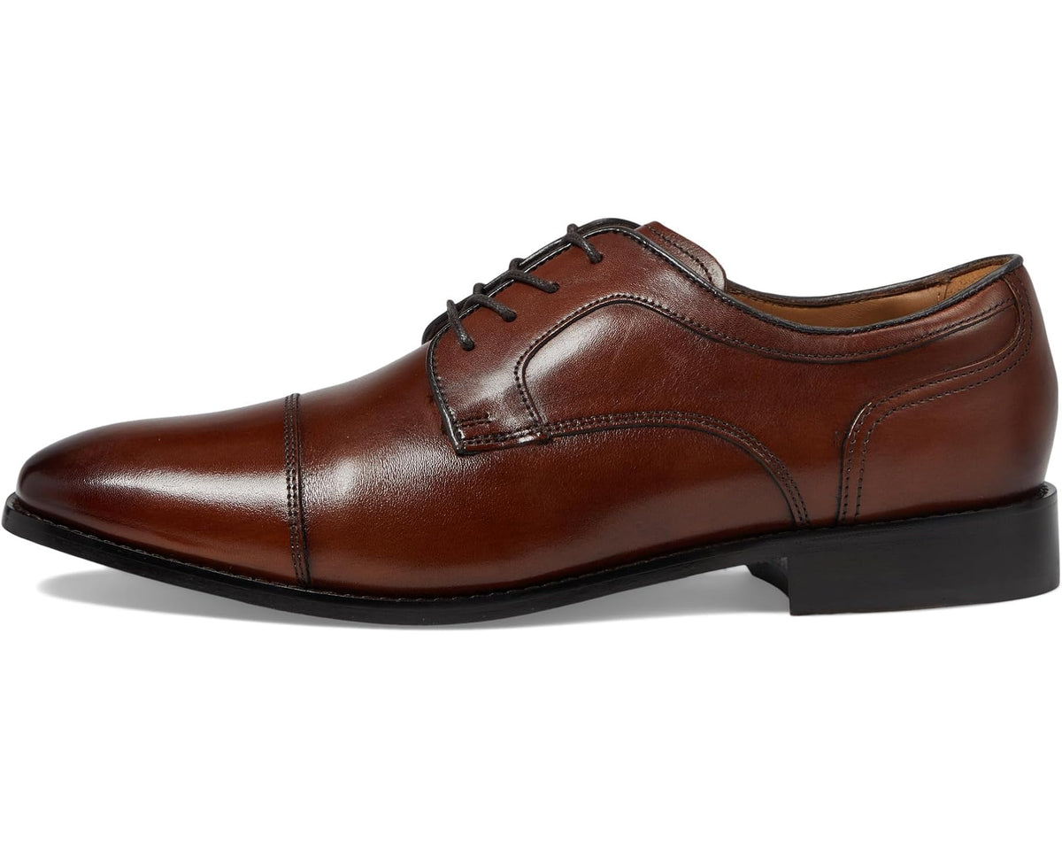 Cap-toe oxford shoe profile with lace-up closure and welt stitching, cognac leather