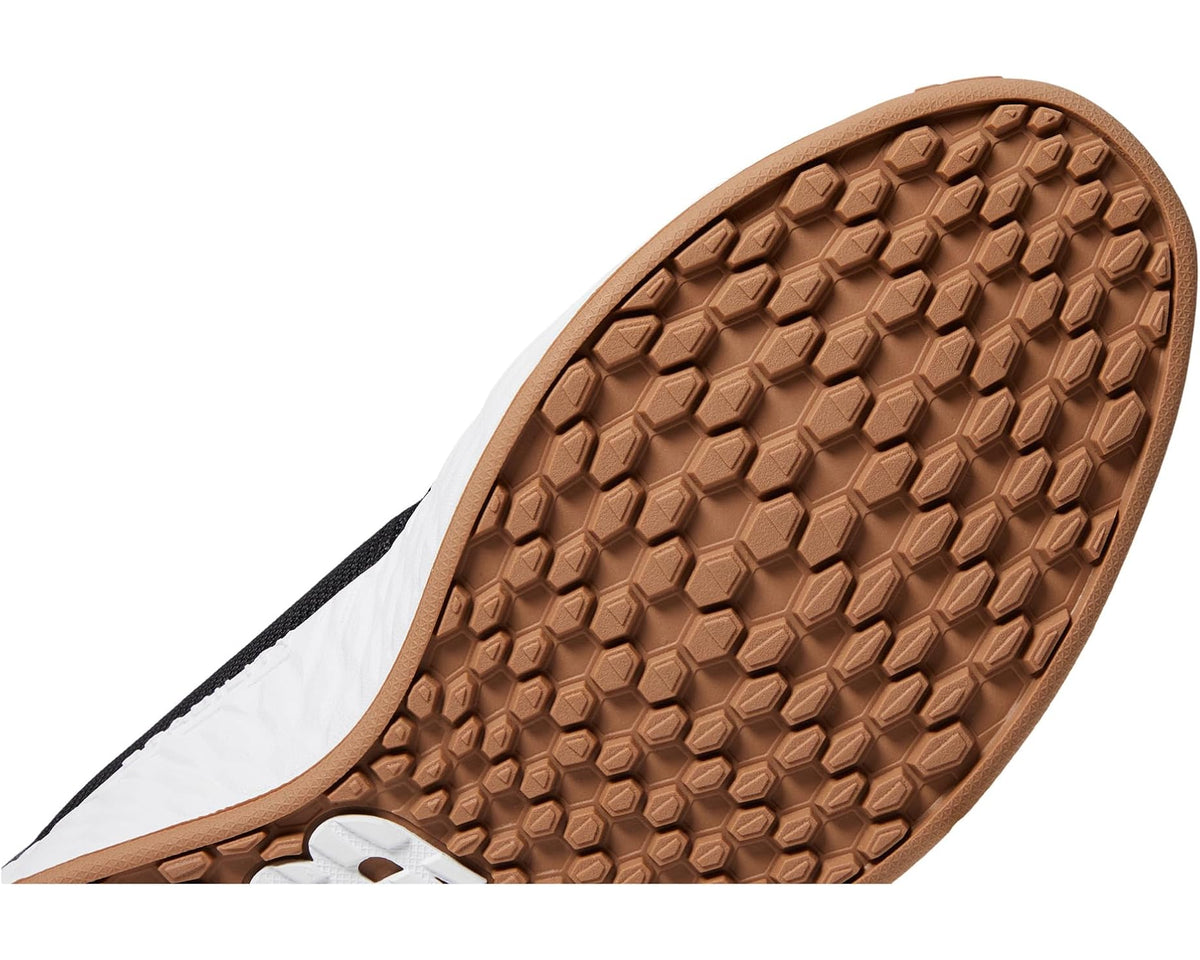 Gum-brown New Balance golf outsole with white edge and textured traction lugs