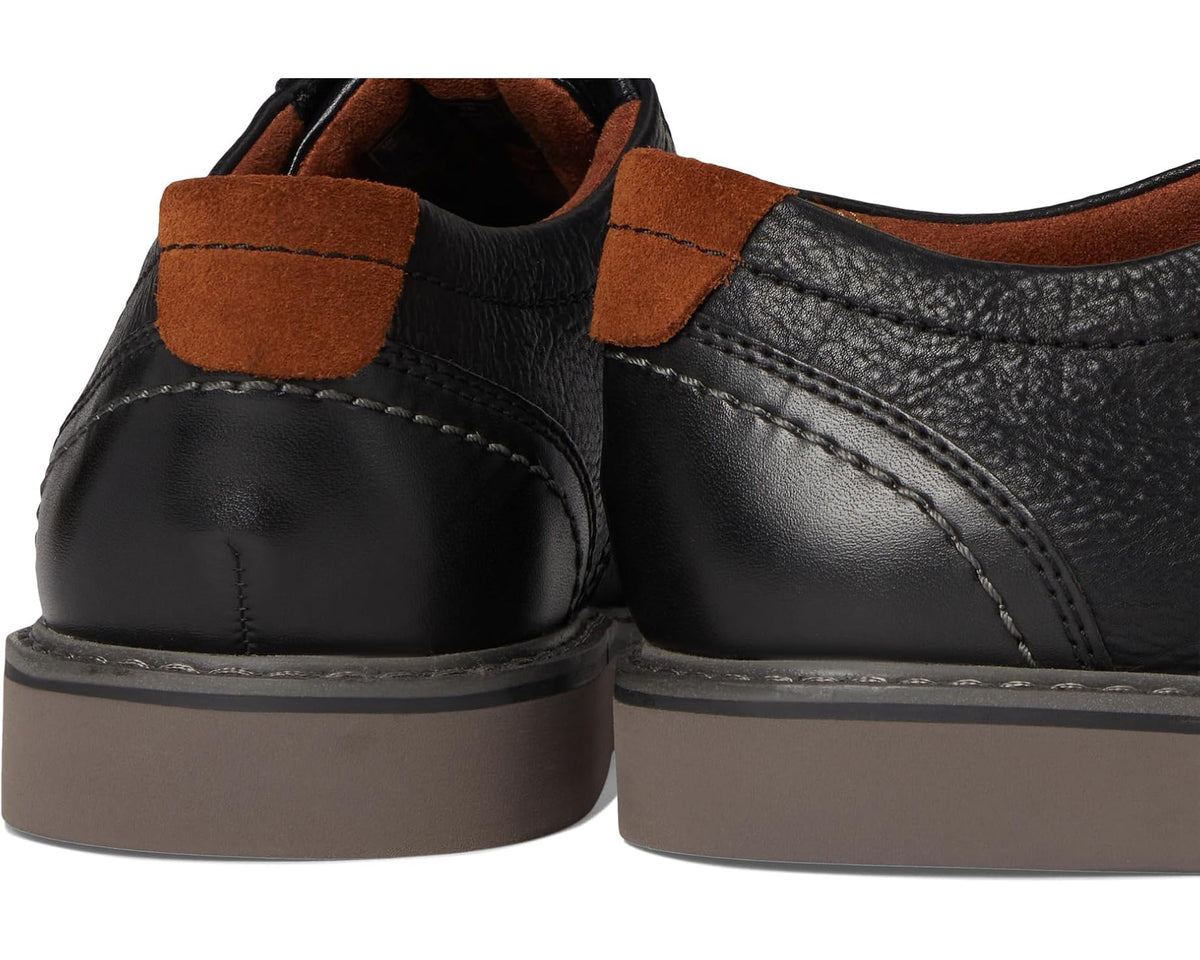 Black leather shoe heel with tan suede tab and stitched collar seams