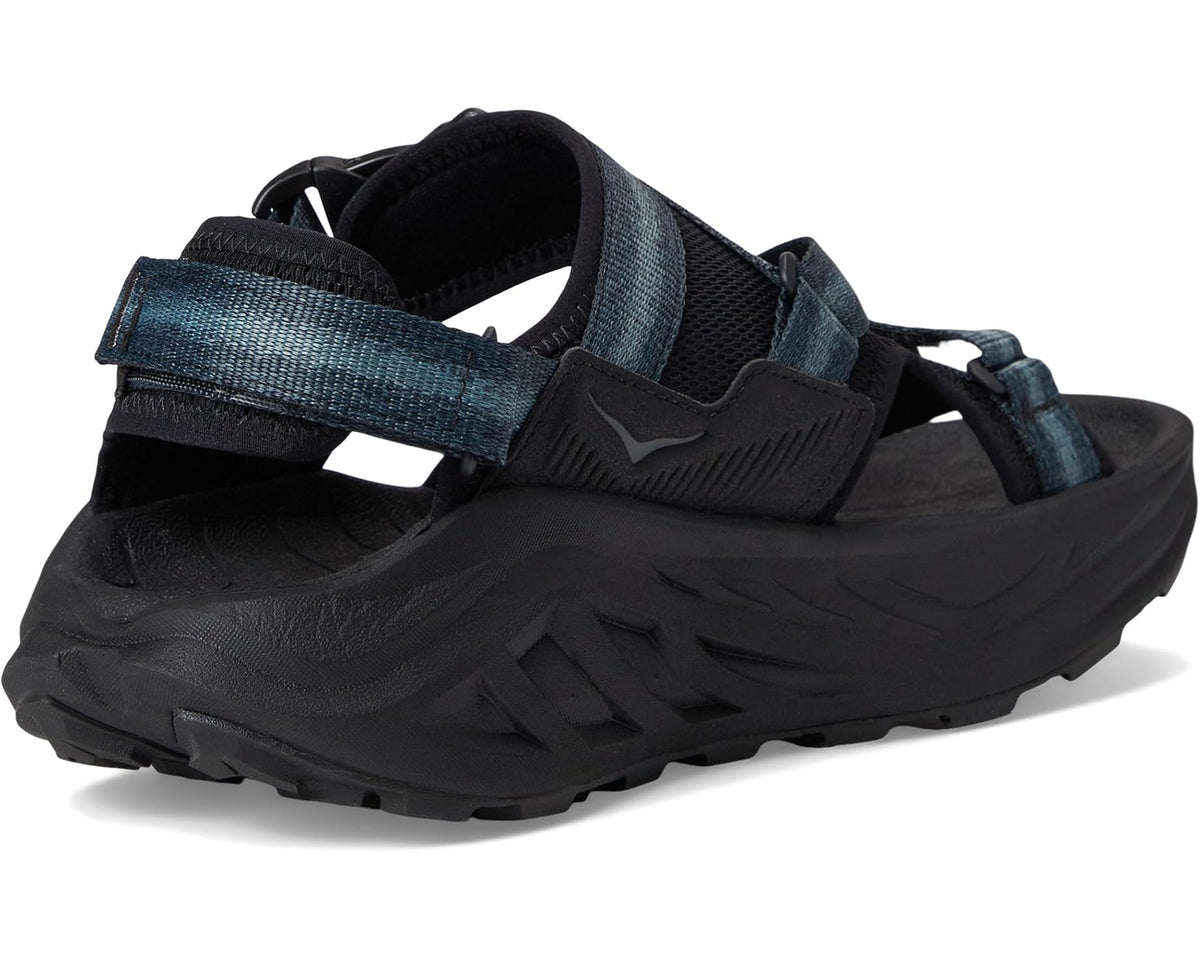 Men's Hoka Infini Hike TC trail sandals, heel view with black upper and blue webbing