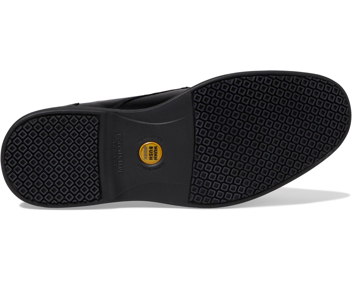 Black oxford shoe outsole with textured tread and brand badge on heel