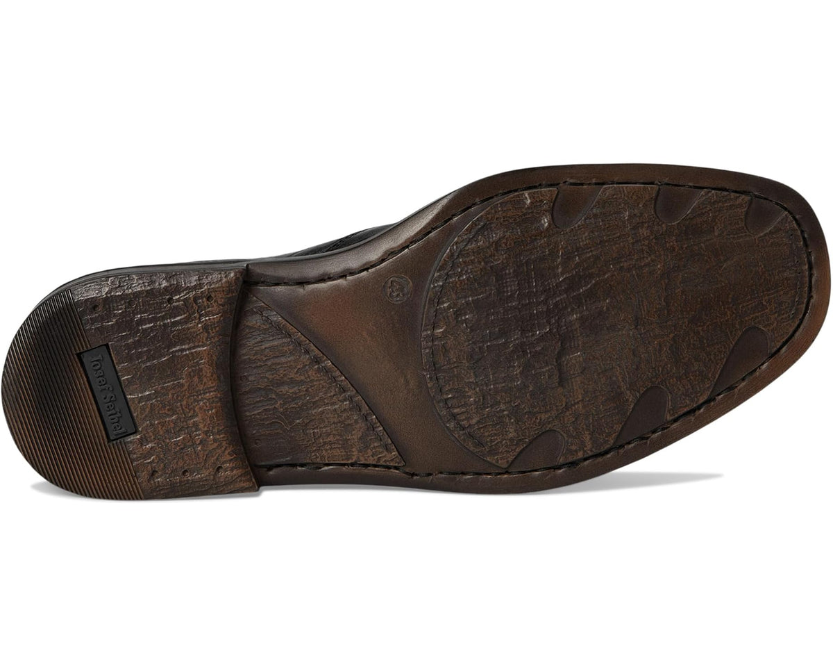 Black leather slip-on shoe outsole with textured tread and logo patch