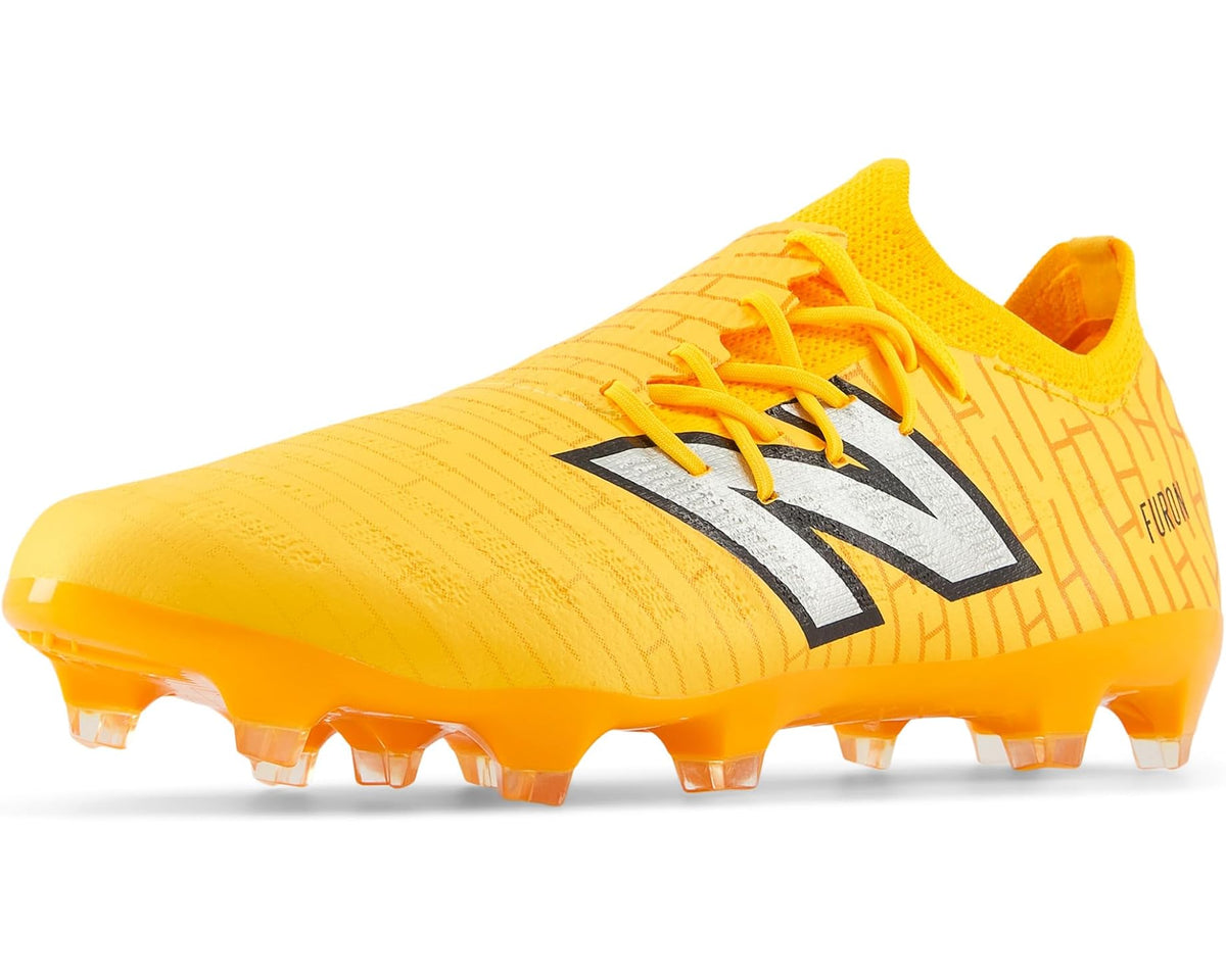 Yellow soccer cleat with lace-up upper, New Balance logo stripe, and firm-ground studs