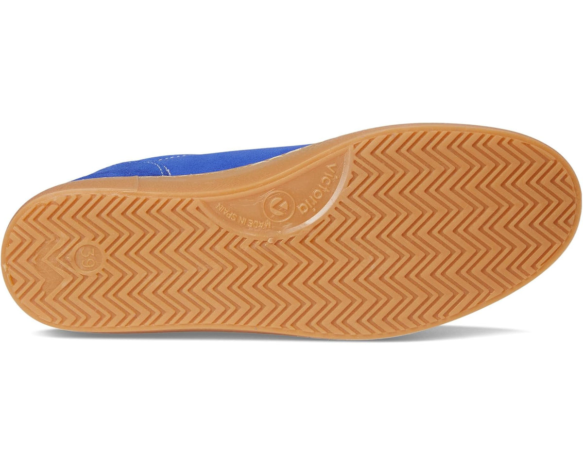 Royal blue suede sneakers with tan gum rubber outsole and textured grip