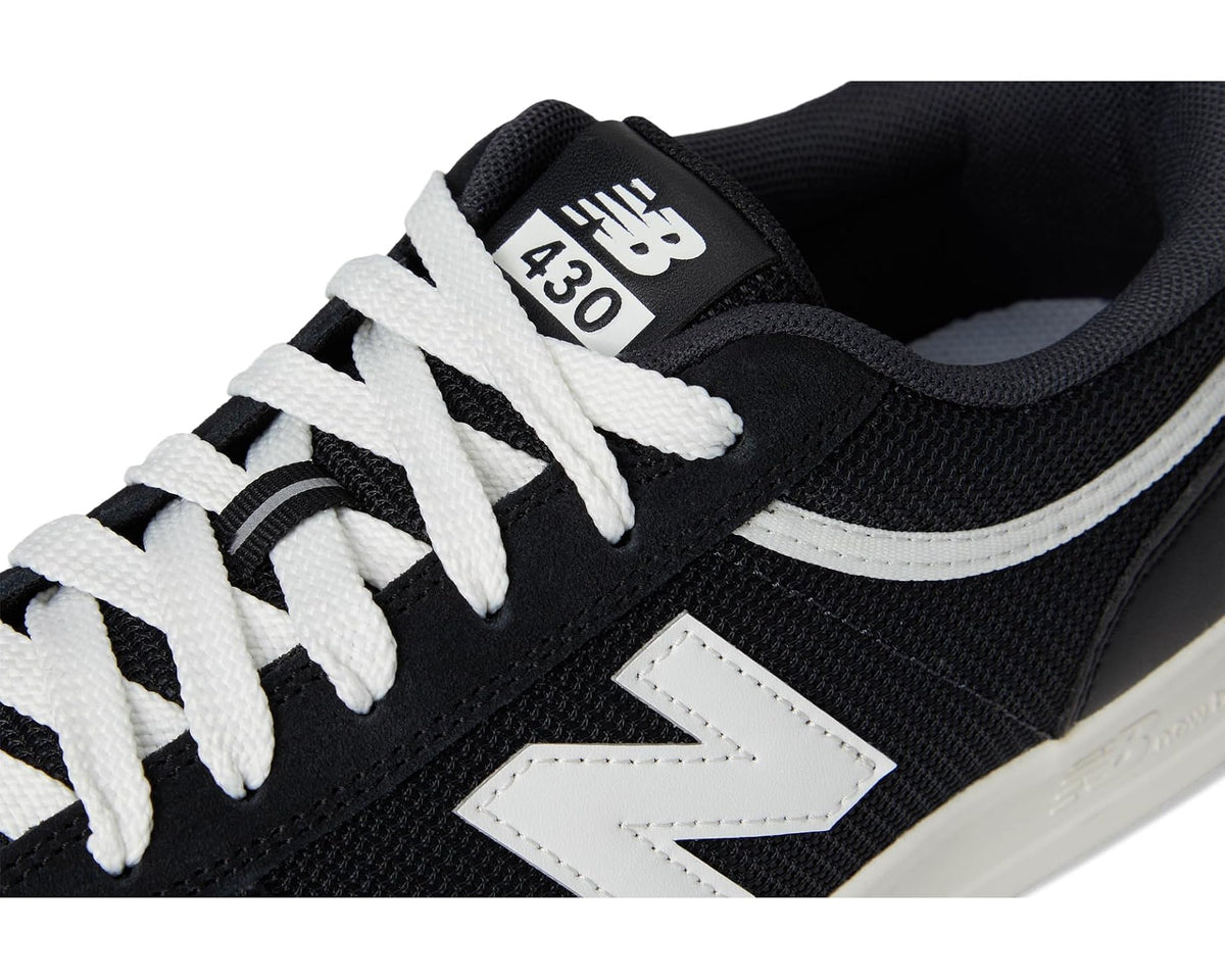 Unisex New Balance Numeric 430 black sneaker close-up of laces and 430 tongue patch