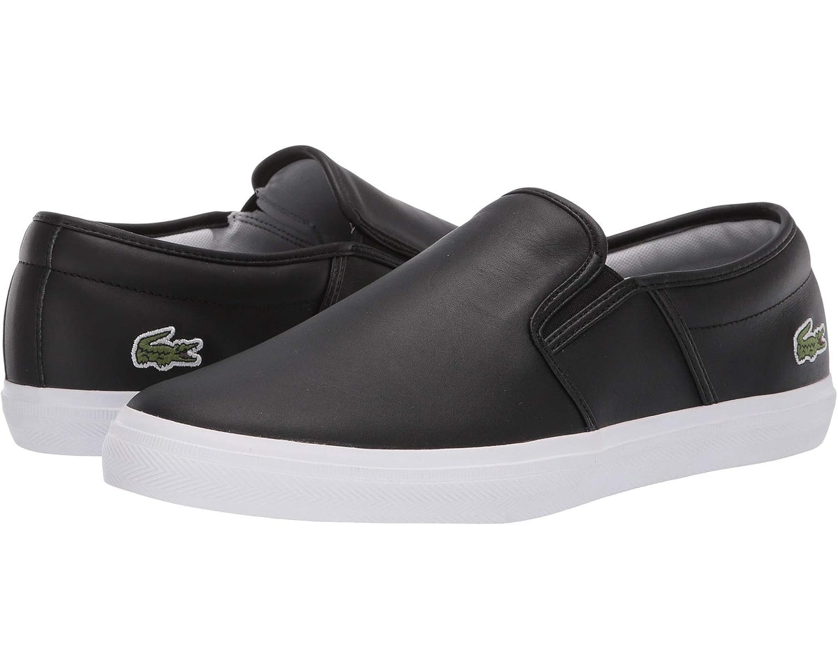 Black slip-on leather sneakers with green Lacoste logo and white rubber sole