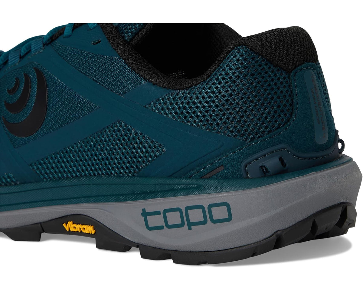 Men's teal trail shoe close-up of upper stitching, lace area, and heel tab
