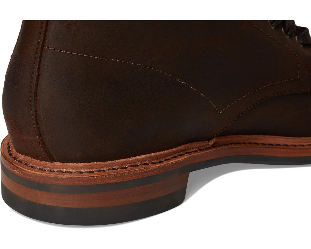 Brown waxed suede ankle boot heel and sole edge with visible stitching