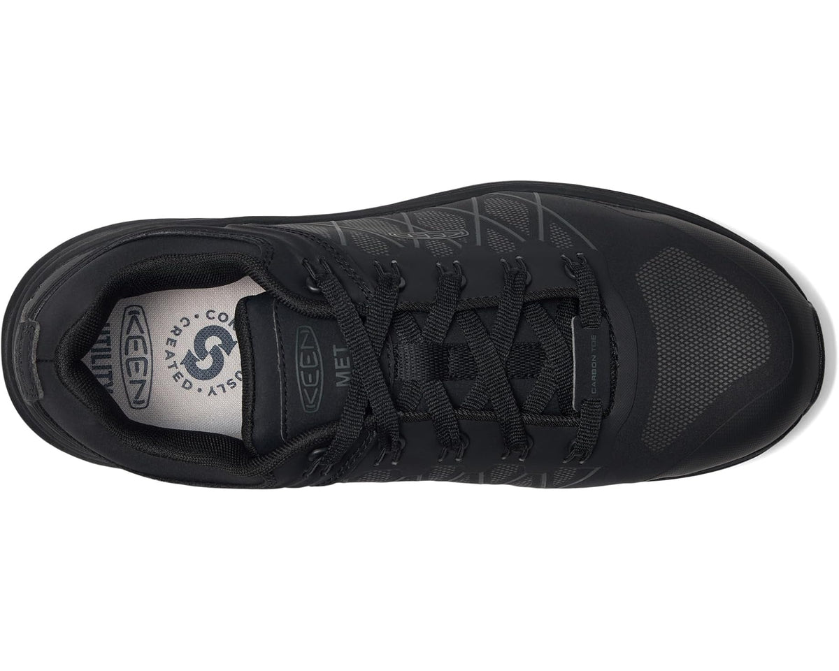 Black work sneaker side view showing carbon-toe guard and lace-up upper