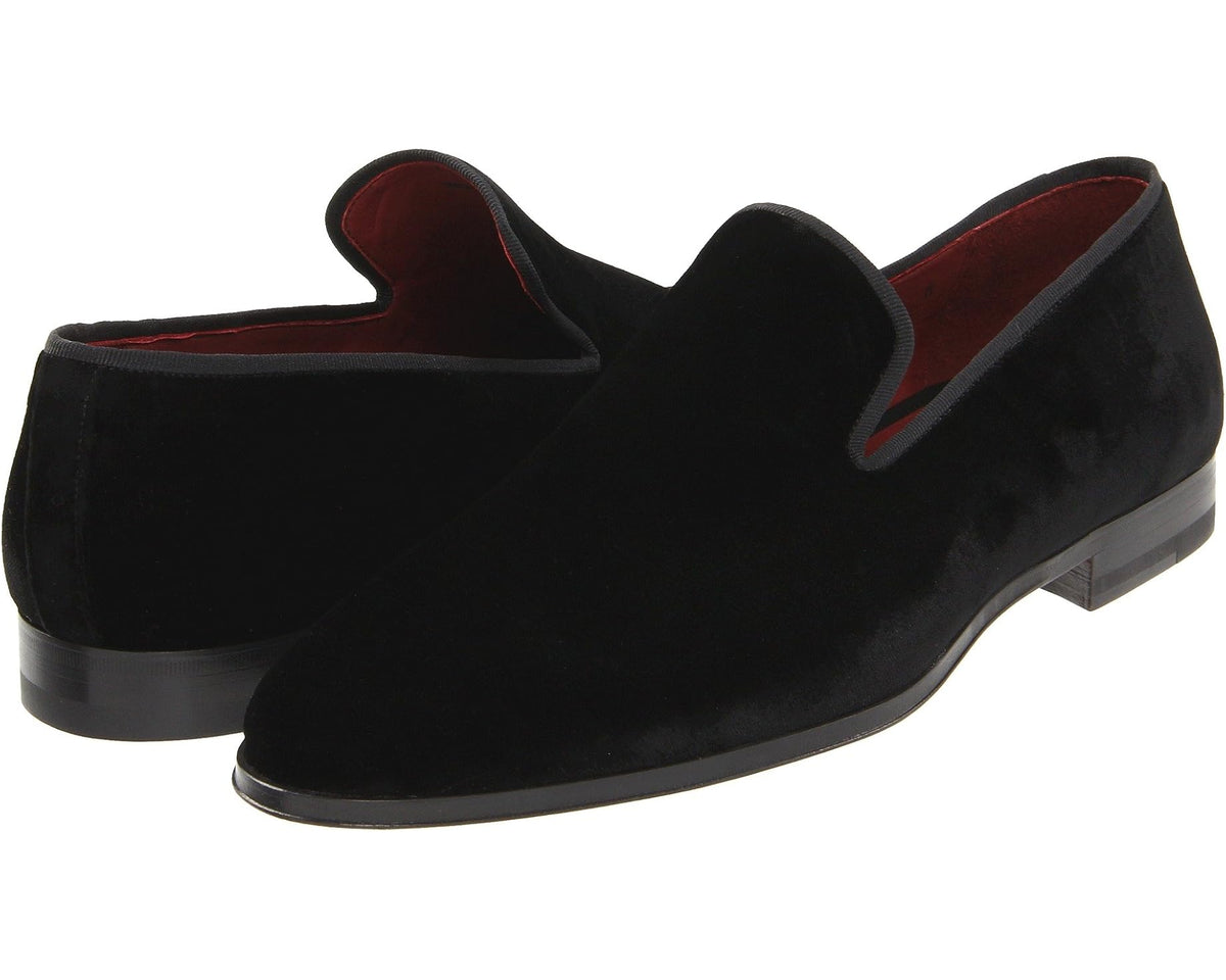 Black suede slip-on loafer with dark rubber sole and moc-style stitching