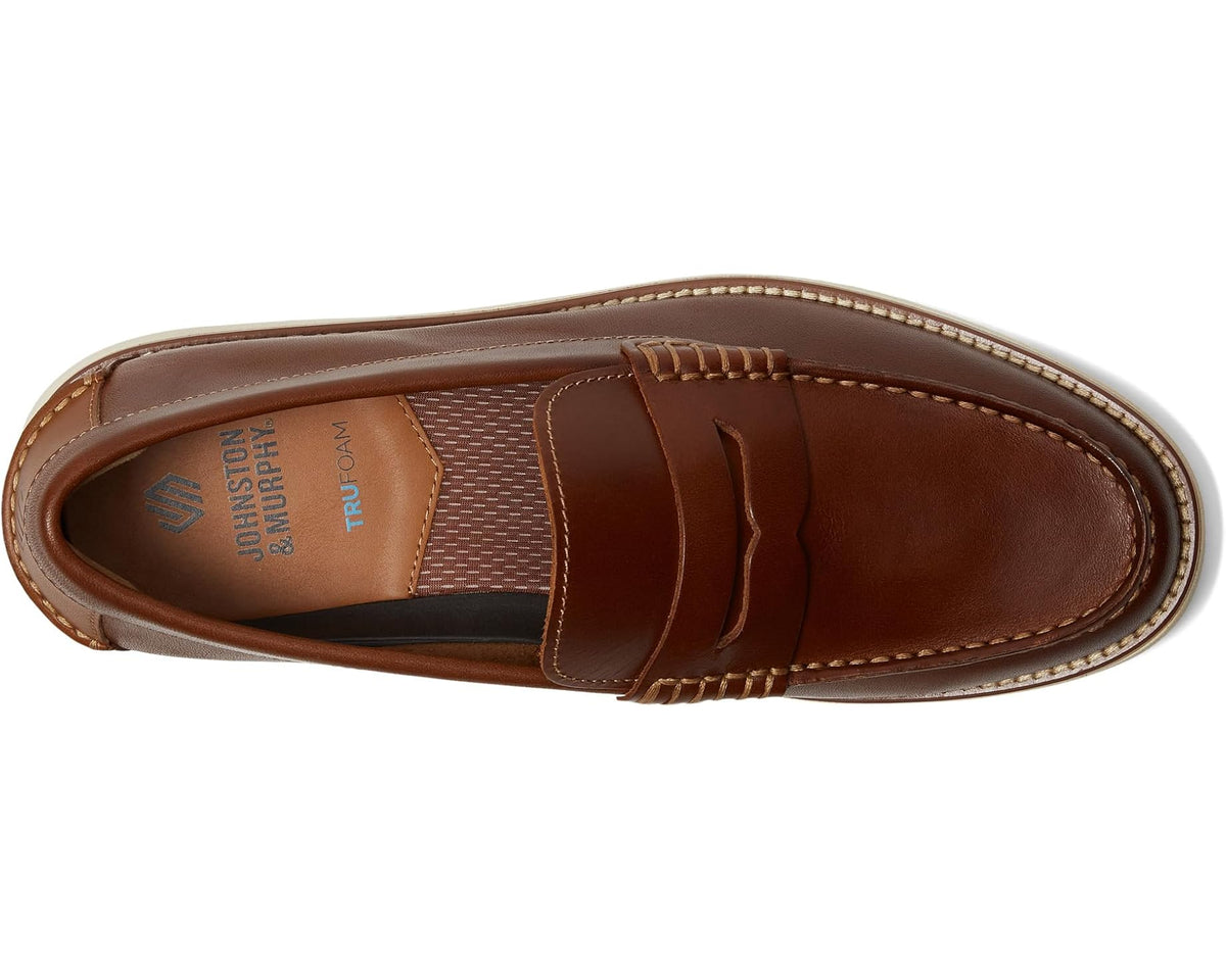 Men's penny loafer interior view, brown leather upper with penny strap and apron stitching