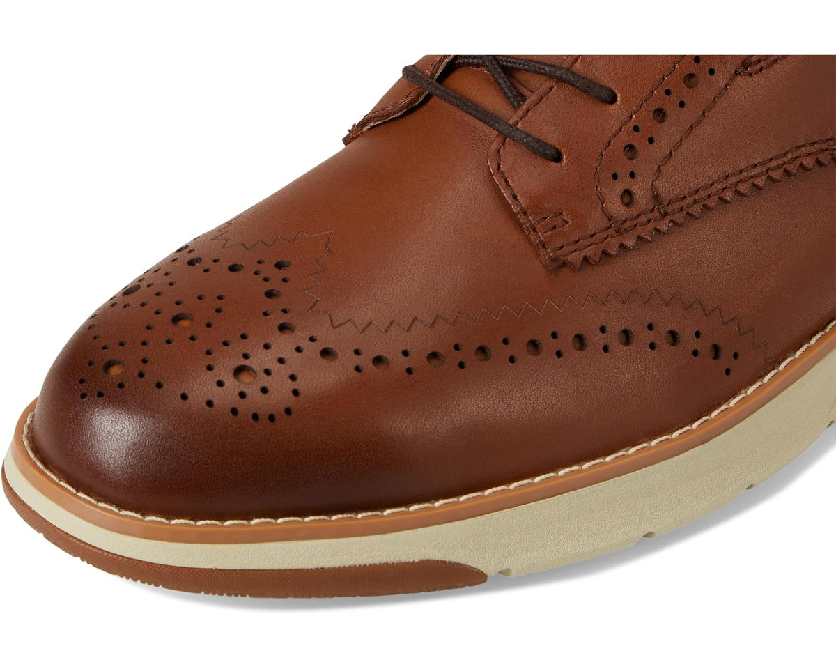 Close-up of tan/brown leather toe with perforation brogue pattern and lace eyelet detail