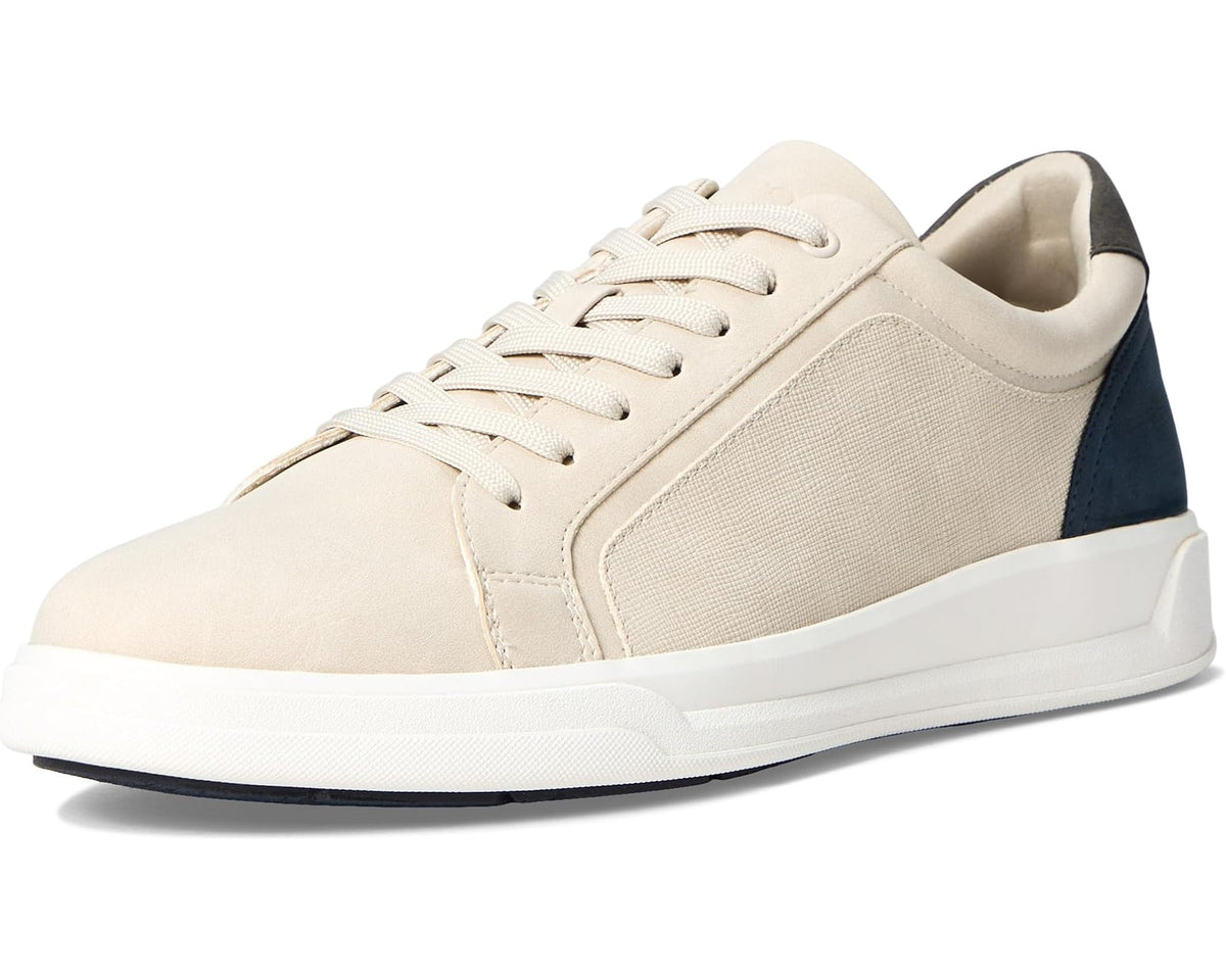 Beige low-top lace-up sneakers with navy heel accent and thick white rubber sole.