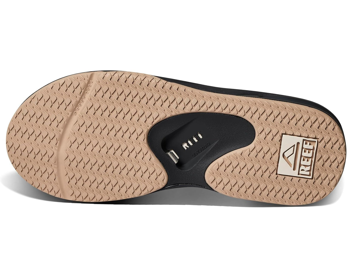Flip-flop sandal outsole with tan tread and black center