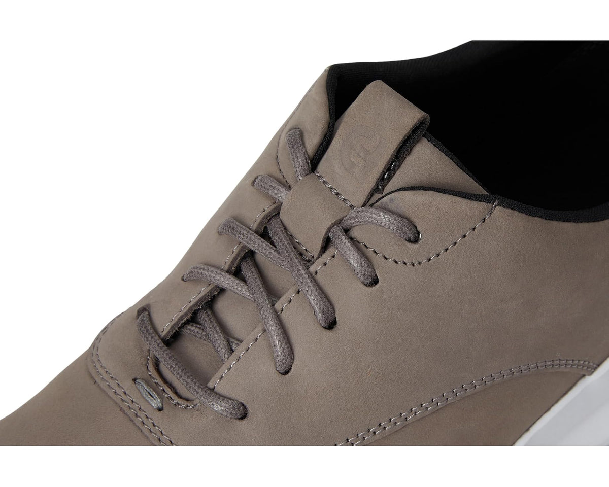 Grey nubuck sneakers close-up of lace-up and stitching on the upper