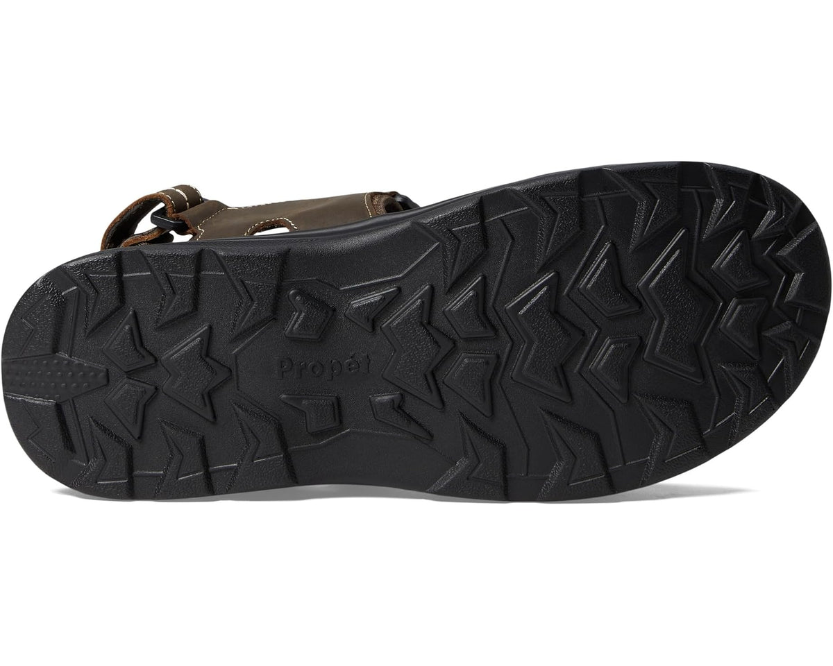 Brown sandal outsole with textured tread and molded pattern, sole facing up