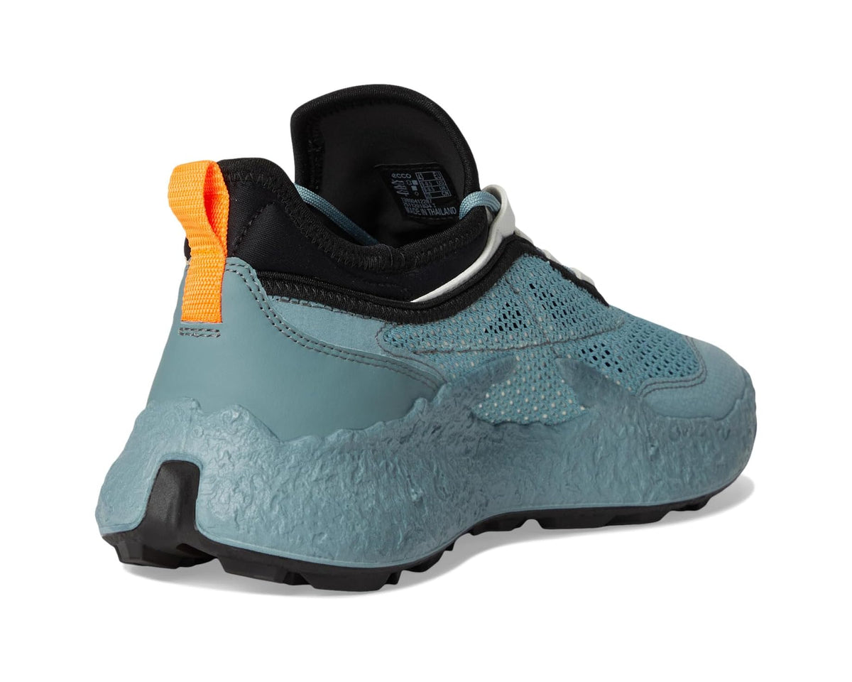 Sky-blue golf shoe heel with black back collar, orange pull tab, and rubber sole