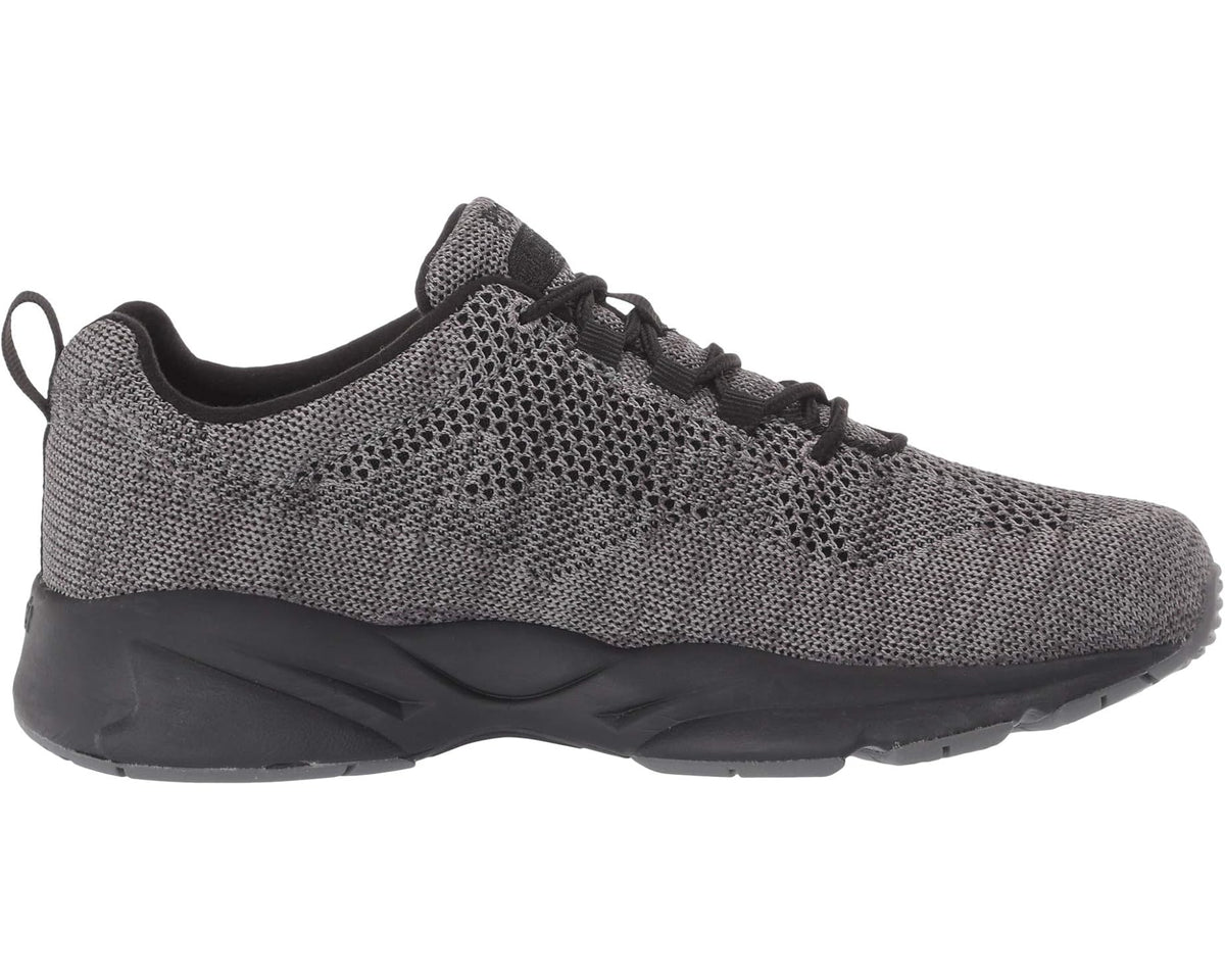 Men's Propet Stability Fly sneaker, angled side view, grey mesh knit with black sole