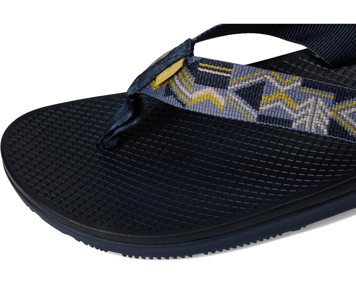 Men's flip-flop sandal close-up: navy strap with yellow geometric pattern