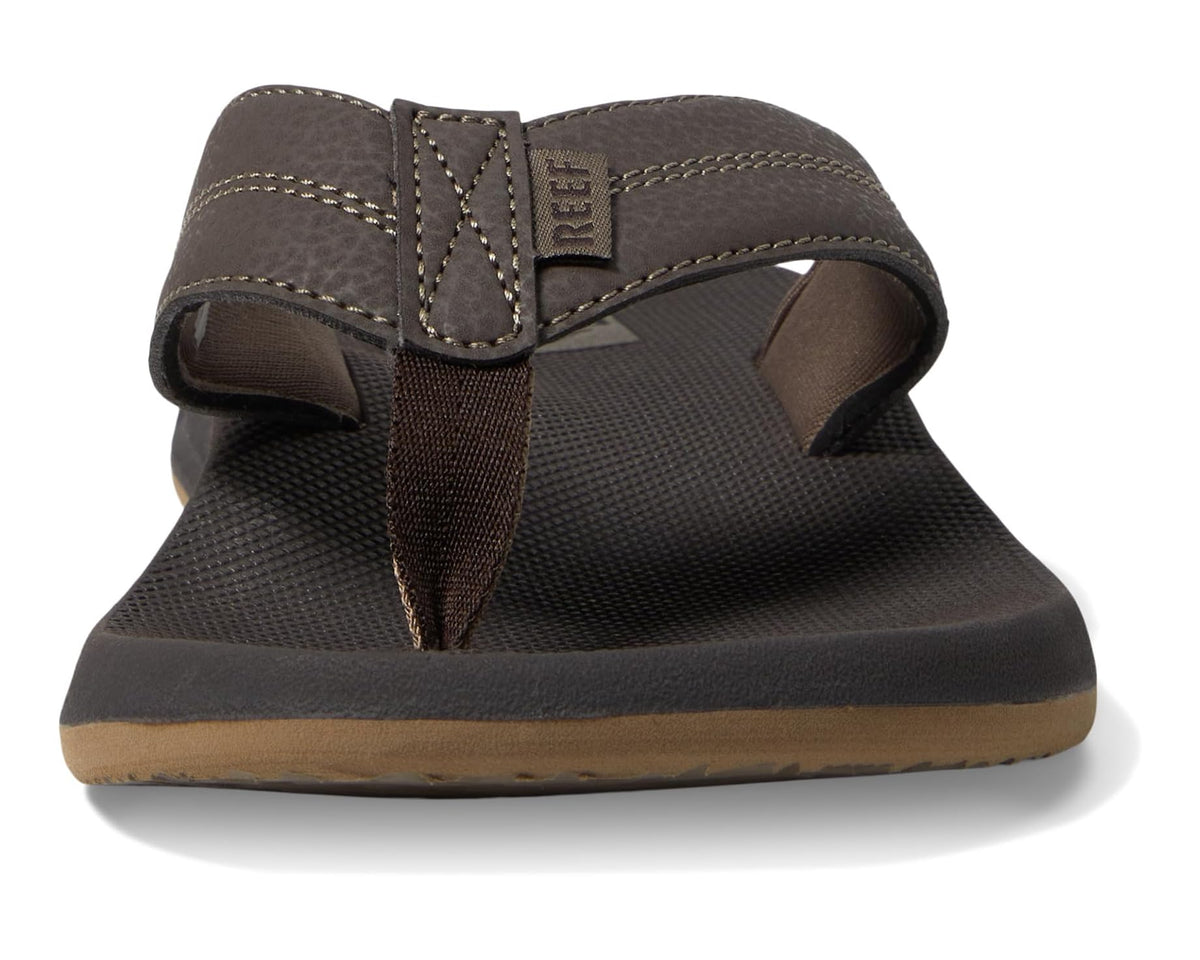 Men's brown flip-flop showing textured strap and stitched fabric upper detail.