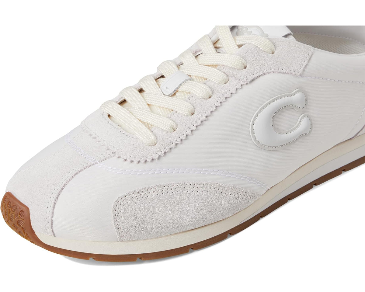 COACH flat sneakers close-up of lace-up and C logo on optic white upper