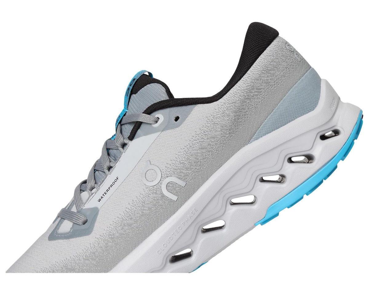 Light gray waterproof trail shoe side with blue accent and vented midsole