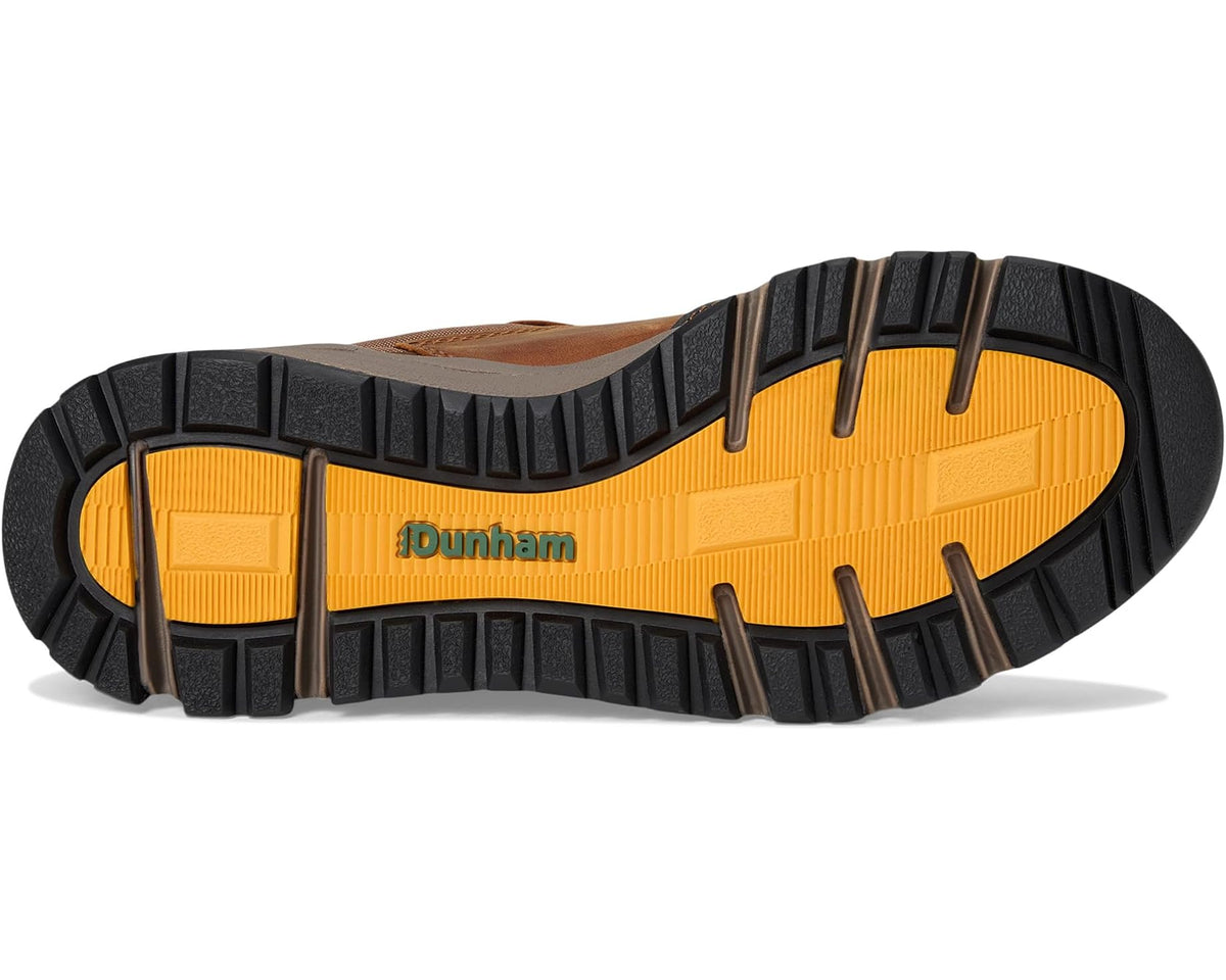 Rugged outsole of a lace-up hiking shoe with black tread and orange center