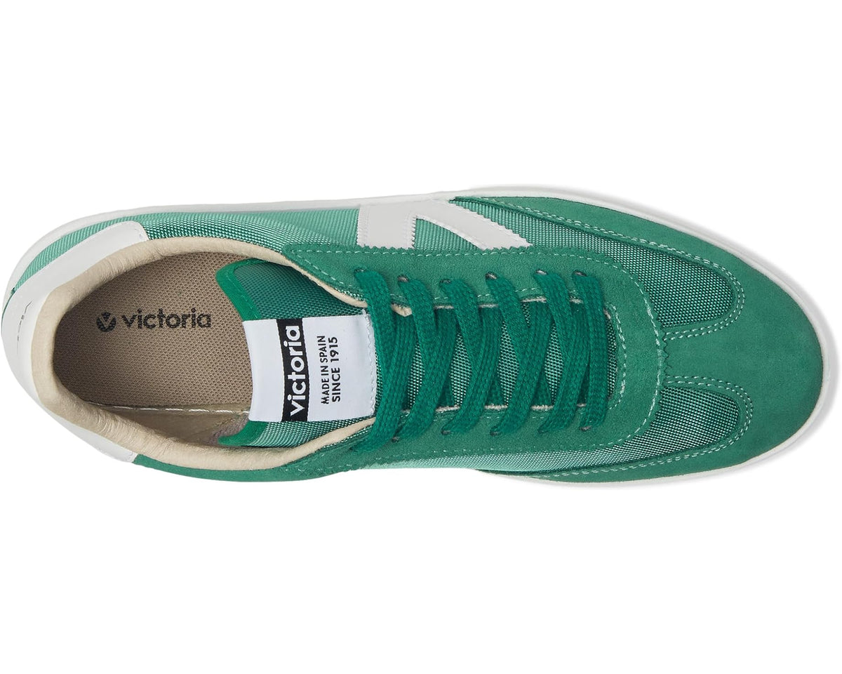 Green lace-up sneaker side view with white V panel and cushioned beige interior