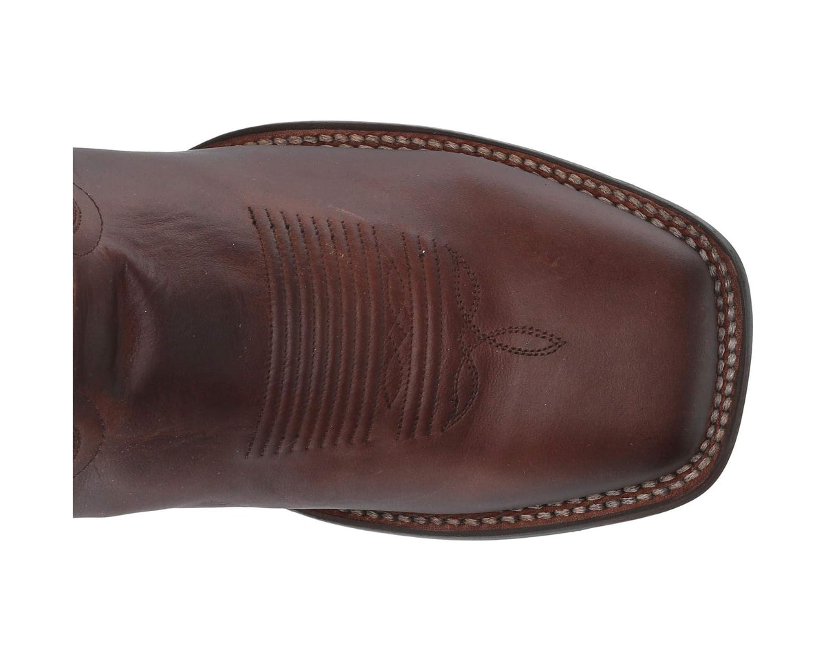 Dark brown leather boot toe with textured stitching and welt trim
