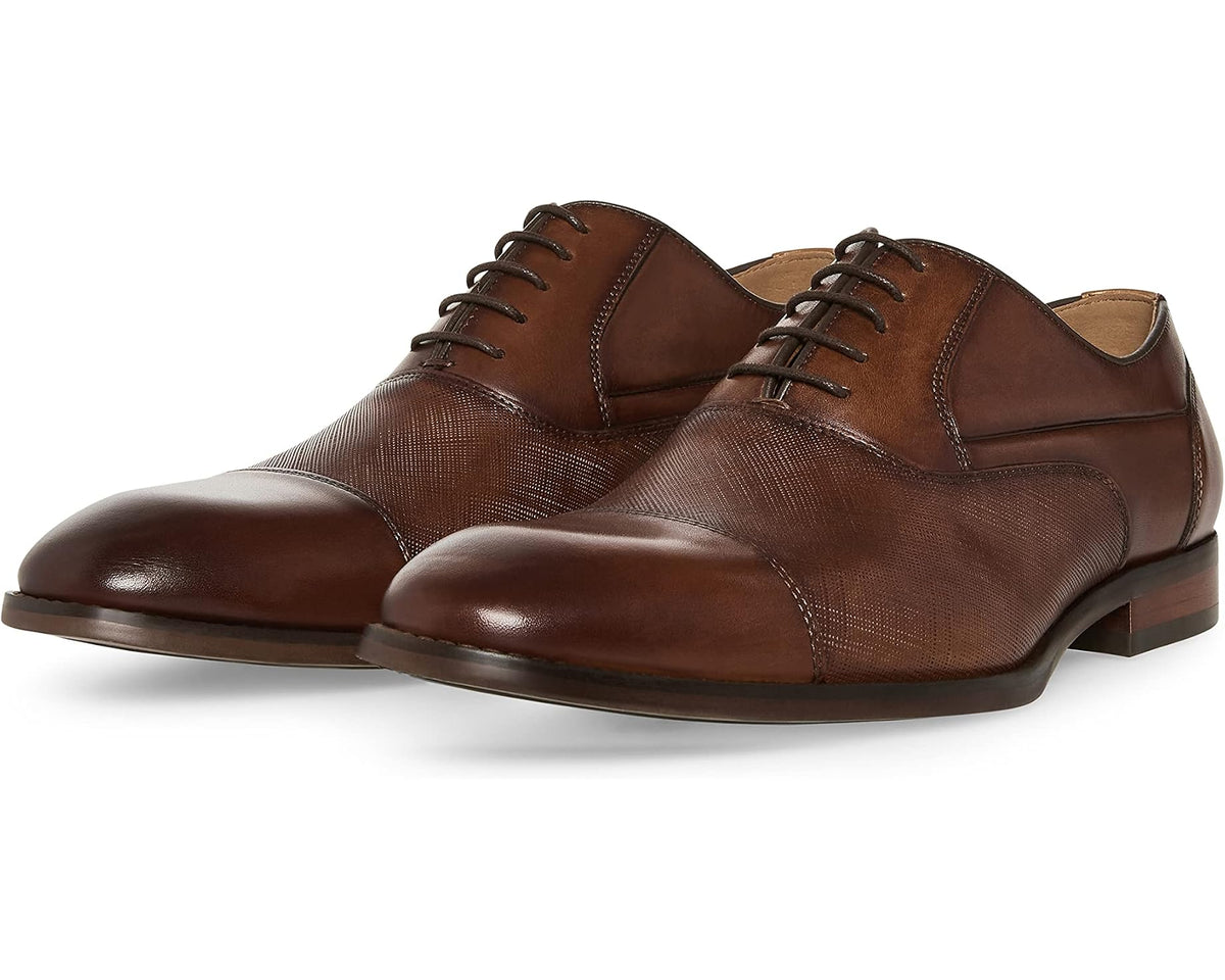 Tan leather lace-up Oxford dress shoes with cap toe and dark brown laces.