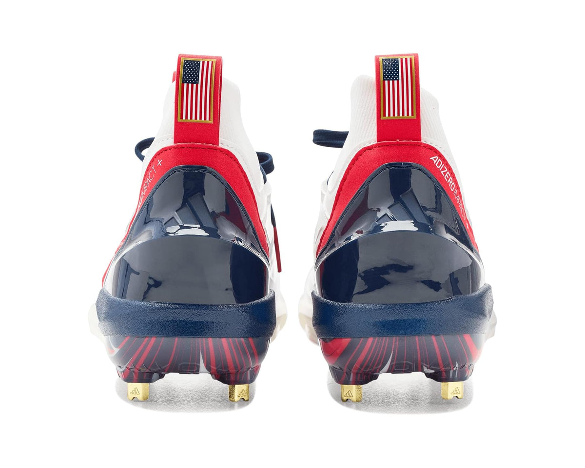 Rear view of adidas baseball cleat shoes in white with red heel pull loops, navy sole, studs
