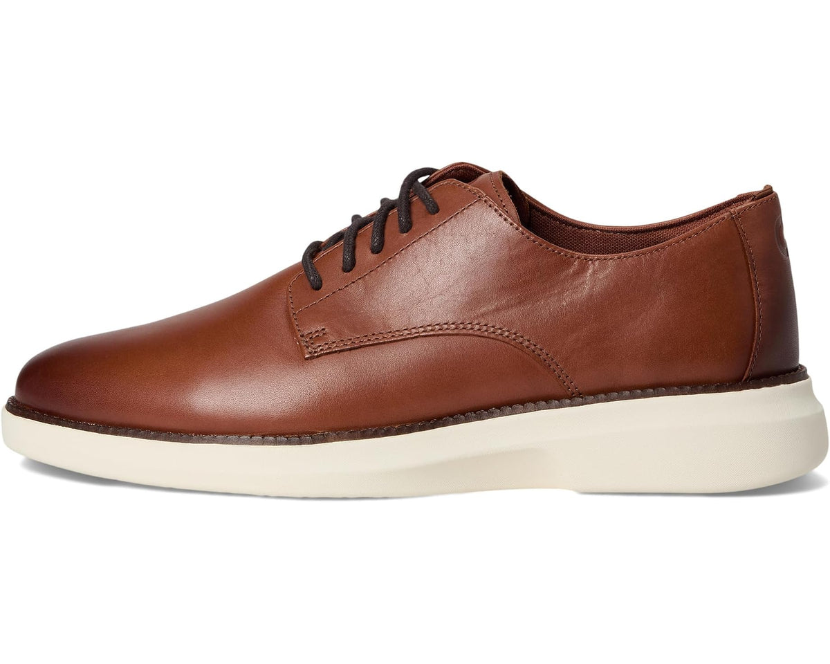 Brown plain-toe Oxford shoes with lace-up closure and cream midsole