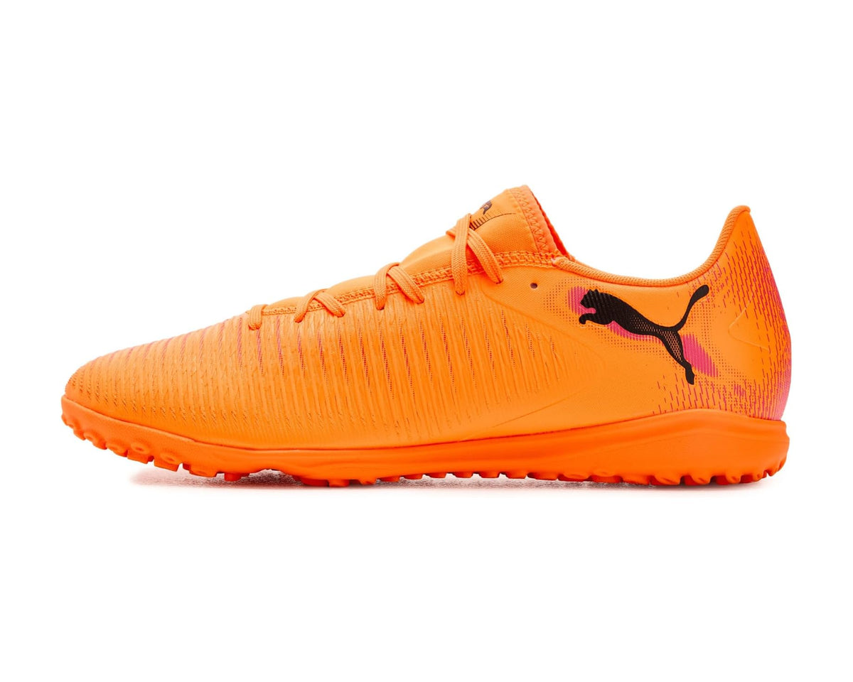 Orange PUMA turf trainer cleats with black cat logo on side
