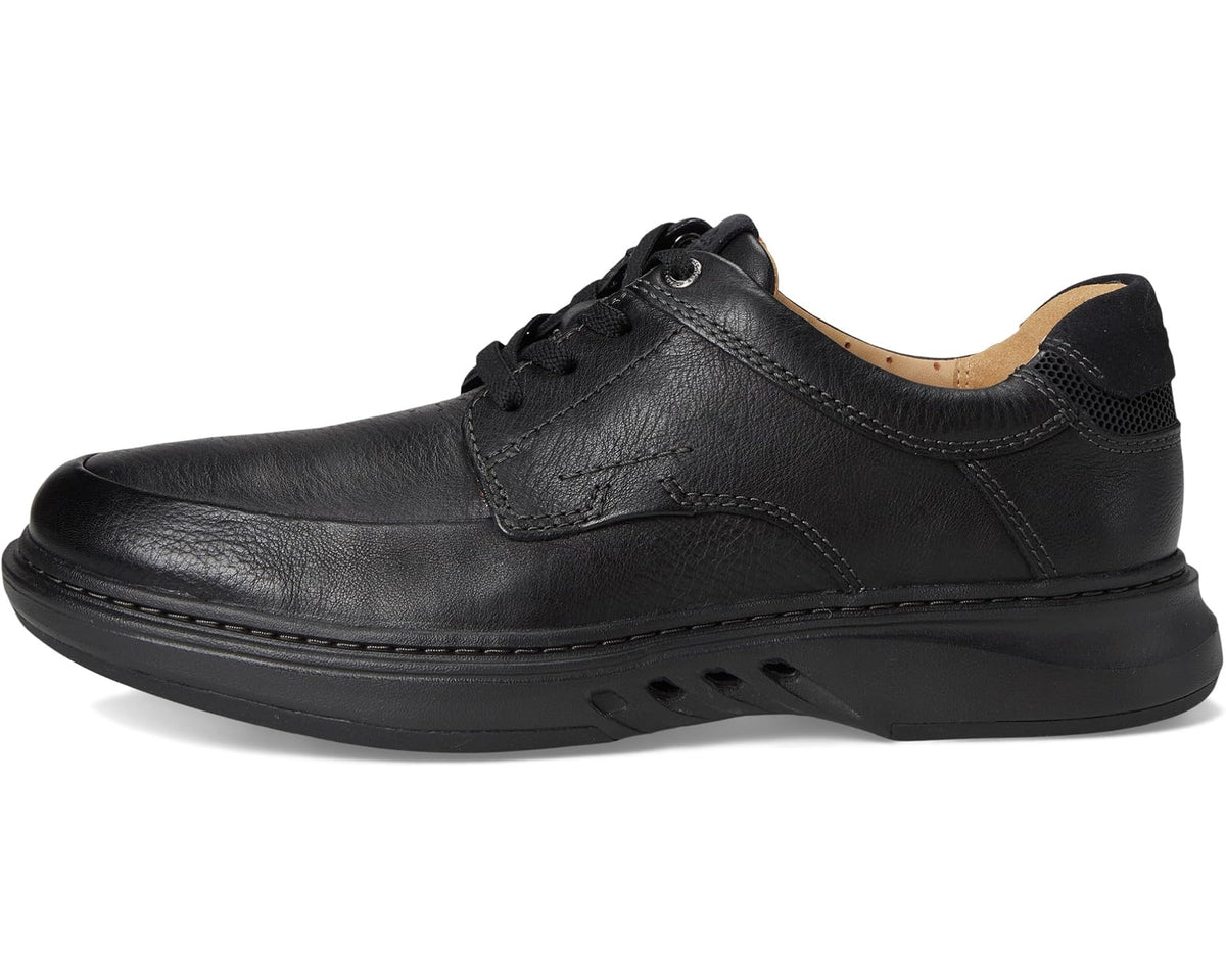 Black leather lace-up Oxford shoe with classic seam stitching and rounded toe.