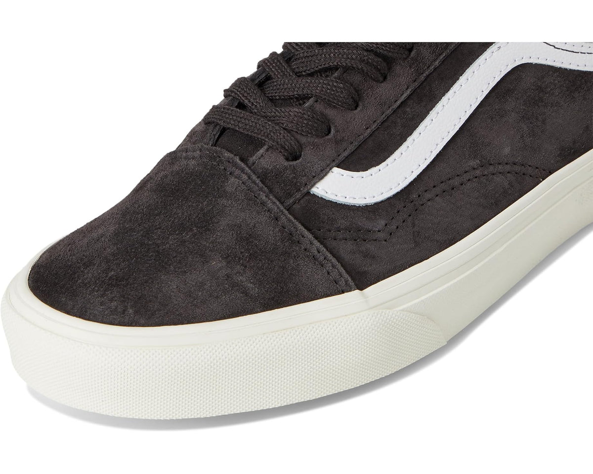 Vans dark suede lace-up sneakers with white trim; front-top close-up