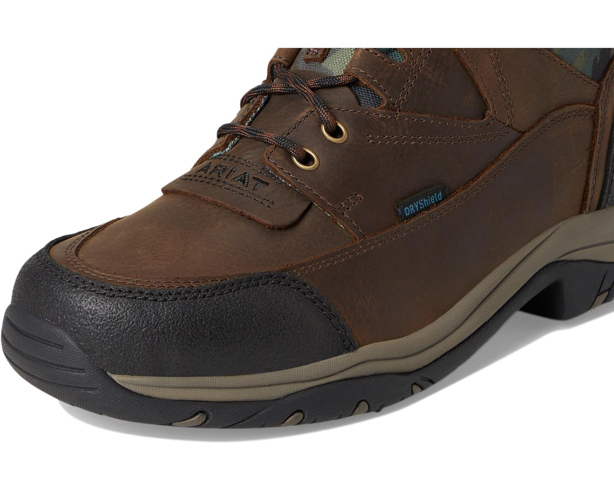 Close-up of dark brown waterproof boot with laces, stitched panels, and DRYShield badge