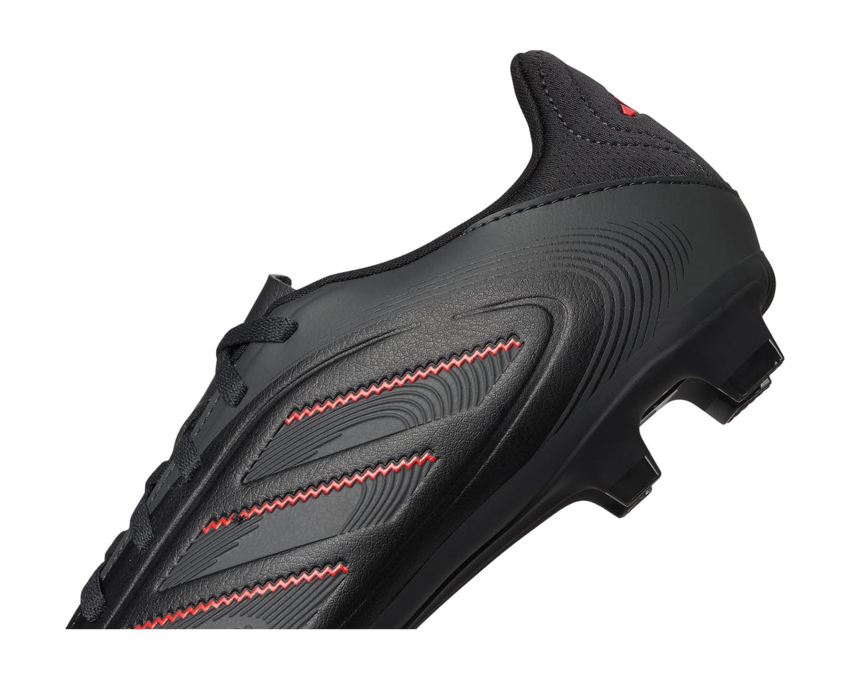 Black soccer cleats side view with red accent stripes and firm-ground studbed