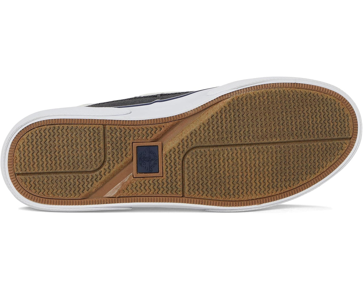Black rubber outsole with textured tread and blue brand patch