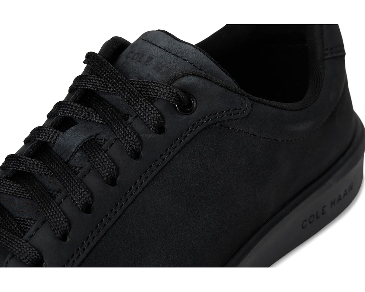 Black nubuck sneakers close-up of laces and eyelets with heel logo