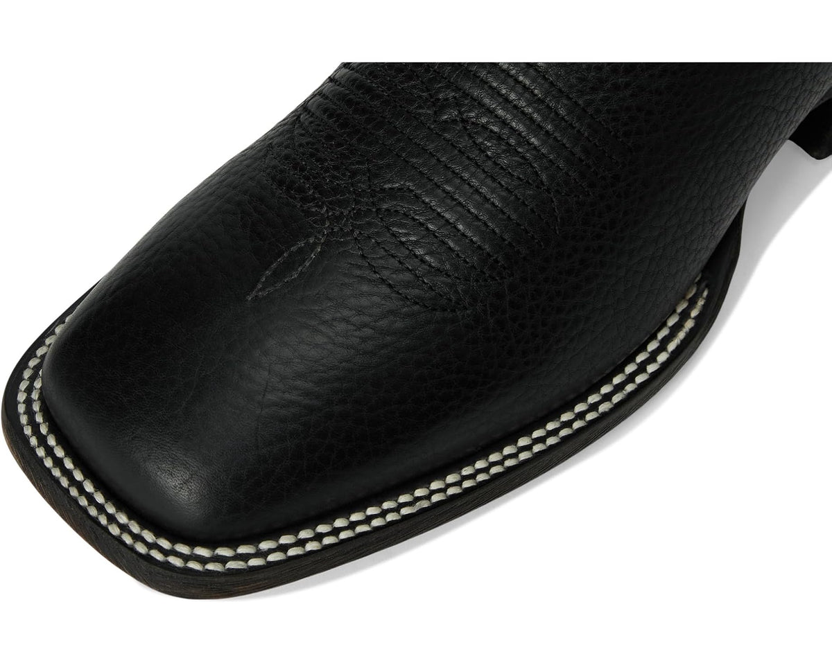 Black leather cowboy boot toe with textured surface and contrasting stitched trim