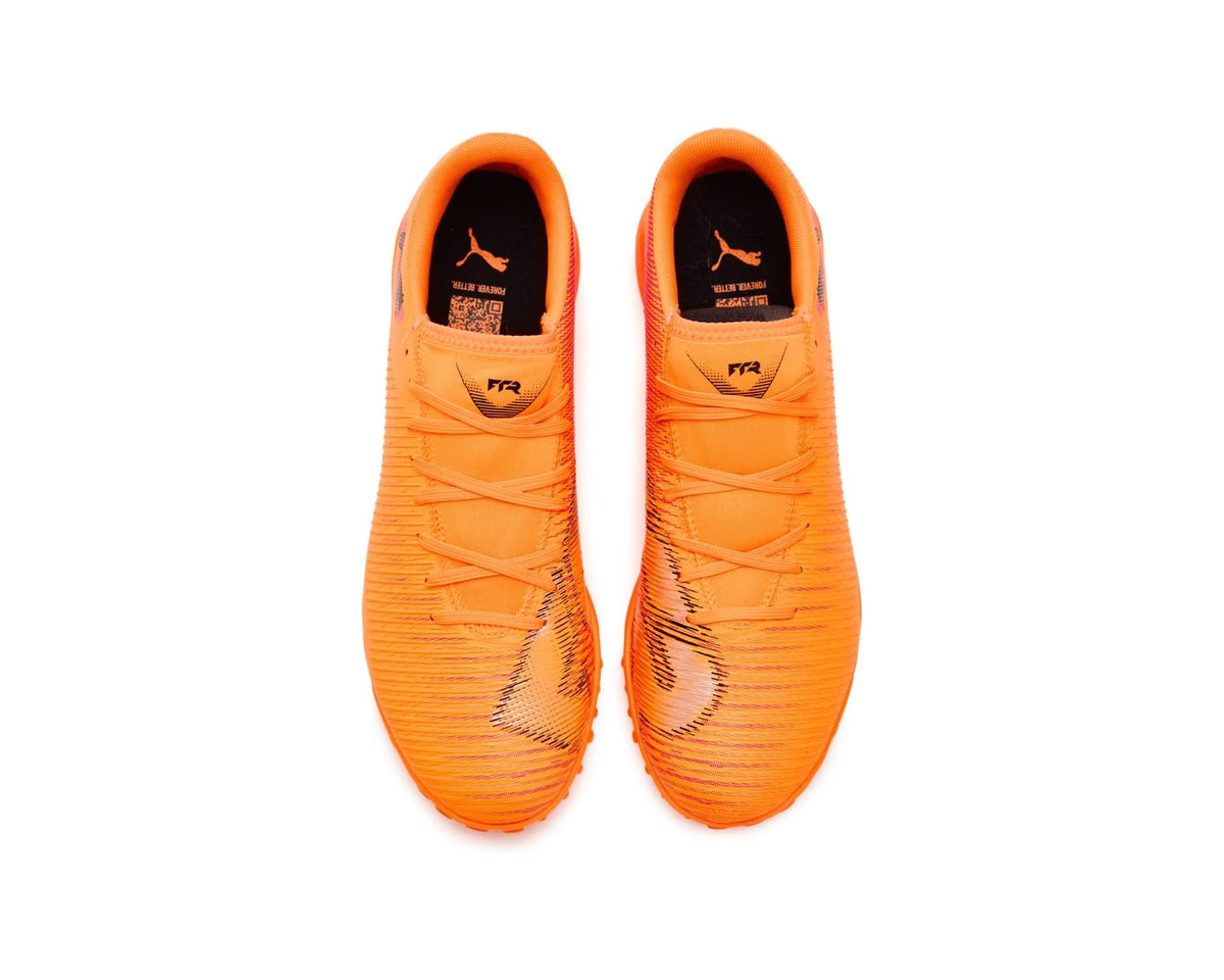 Pair of orange PUMA turf soccer cleats, lace-up with black PUMA branding