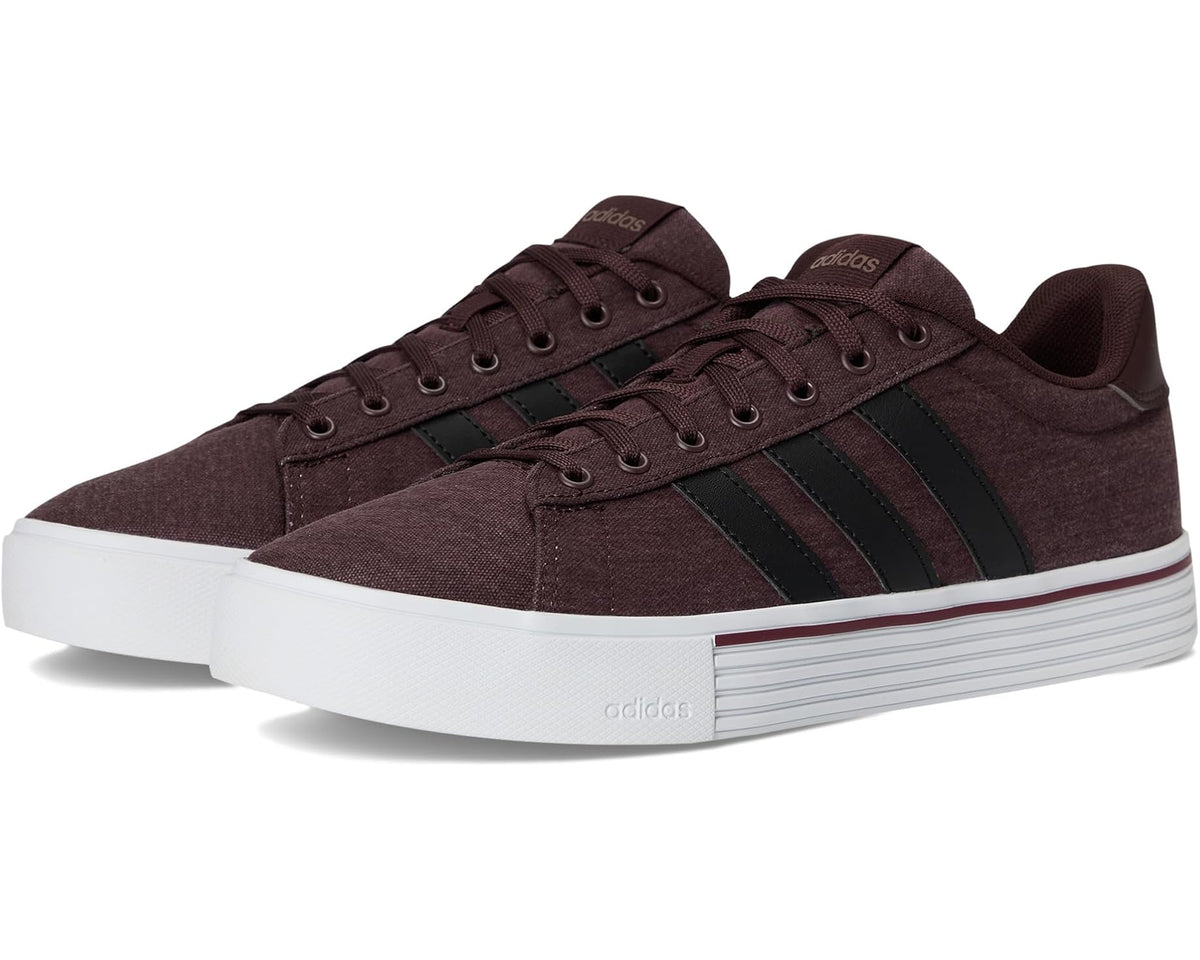 Unisex adidas low-top sneakers in dark brown with black three-stripe accents and white sole