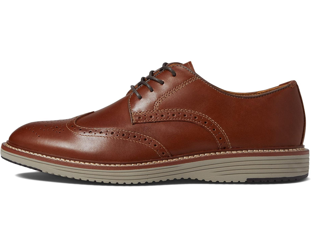 Men's tan lace-up wingtip oxford with brogue detailing and thick striped sole