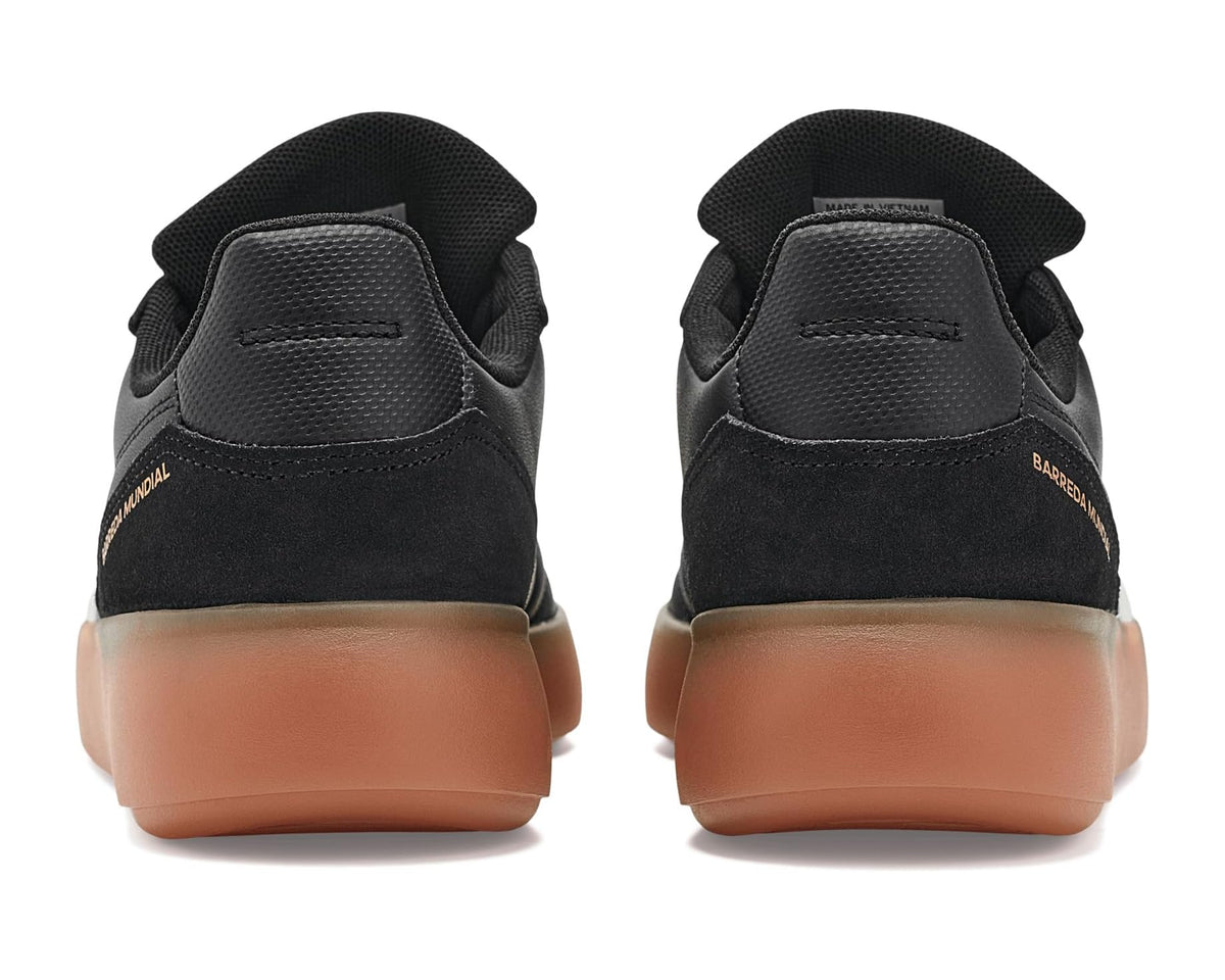 Back view of men's adidas Barreda Mundial sneakers, black with gum heel and suede panels