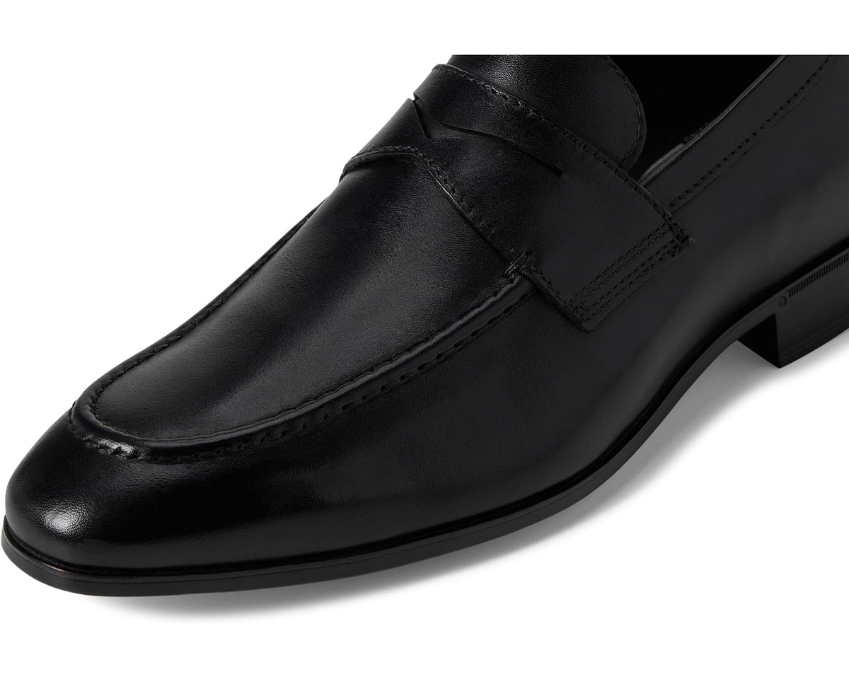 Black leather penny loafer upper close-up with stitched apron and strap