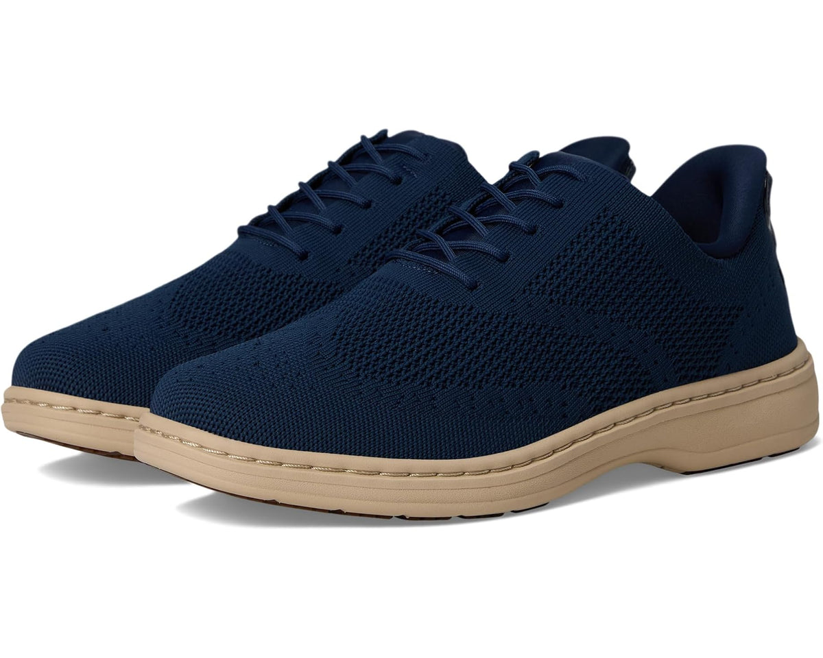 Blue lace-up knit sneaker with cushioned beige rubber sole and low profile design