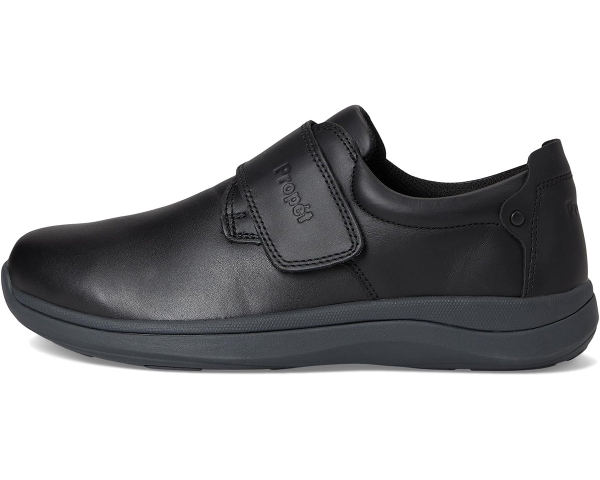 Men's black Propet slip-on shoe with upper strap and low-profile rubber sole