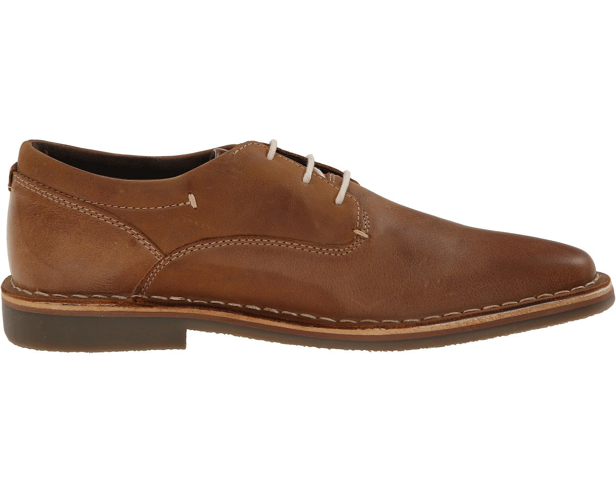 Tan leather lace-up oxford shoe side profile with seam details and flat sole