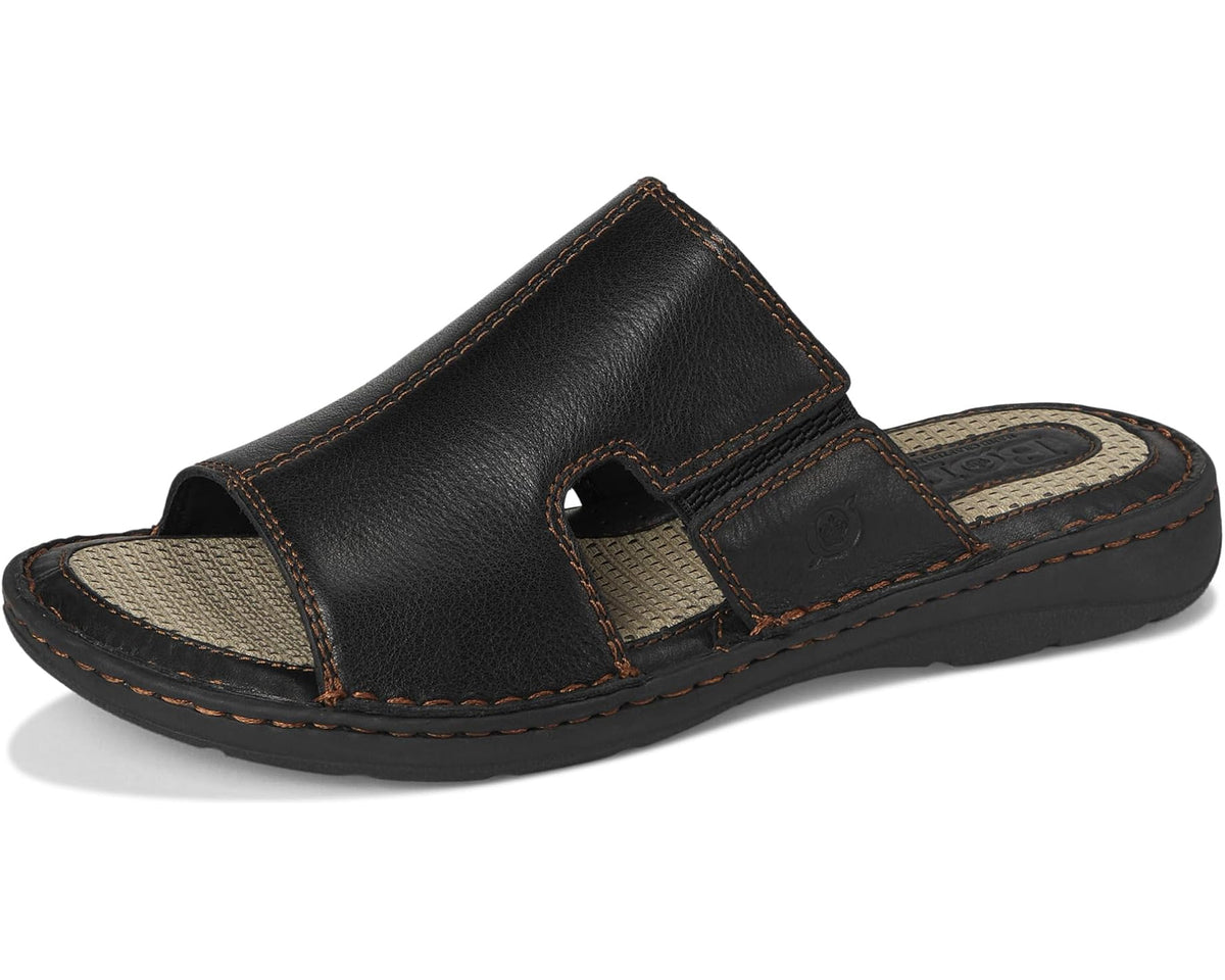 Black leather slide sandals with crossover strap and perforated tan footbed inserts